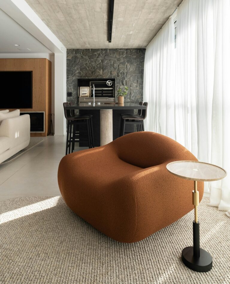 Sunlit interior with white walls and an orange armchair